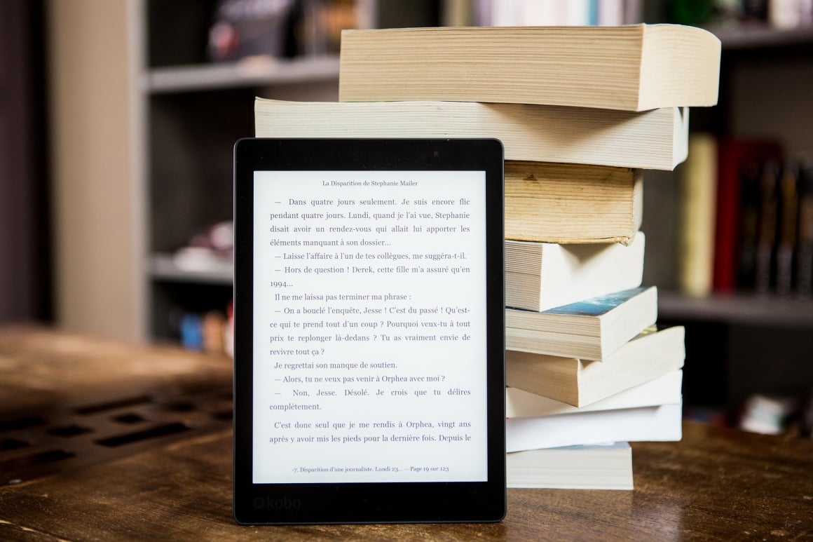 Digital eBook reader next to a stack of physical books EPUB conversion 